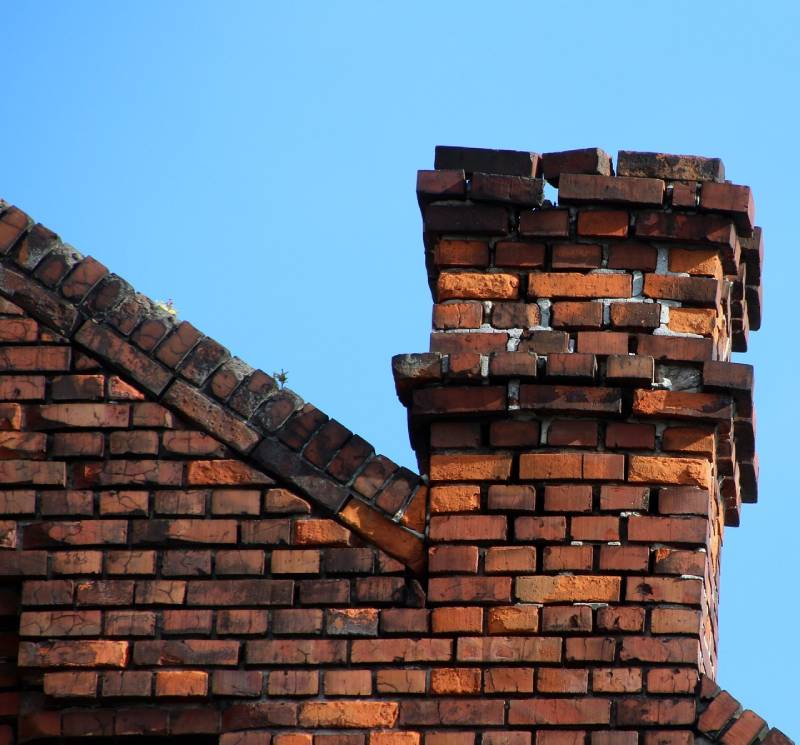 Damaged chimney on an Bolingbrook home showing cracks and missing mortar